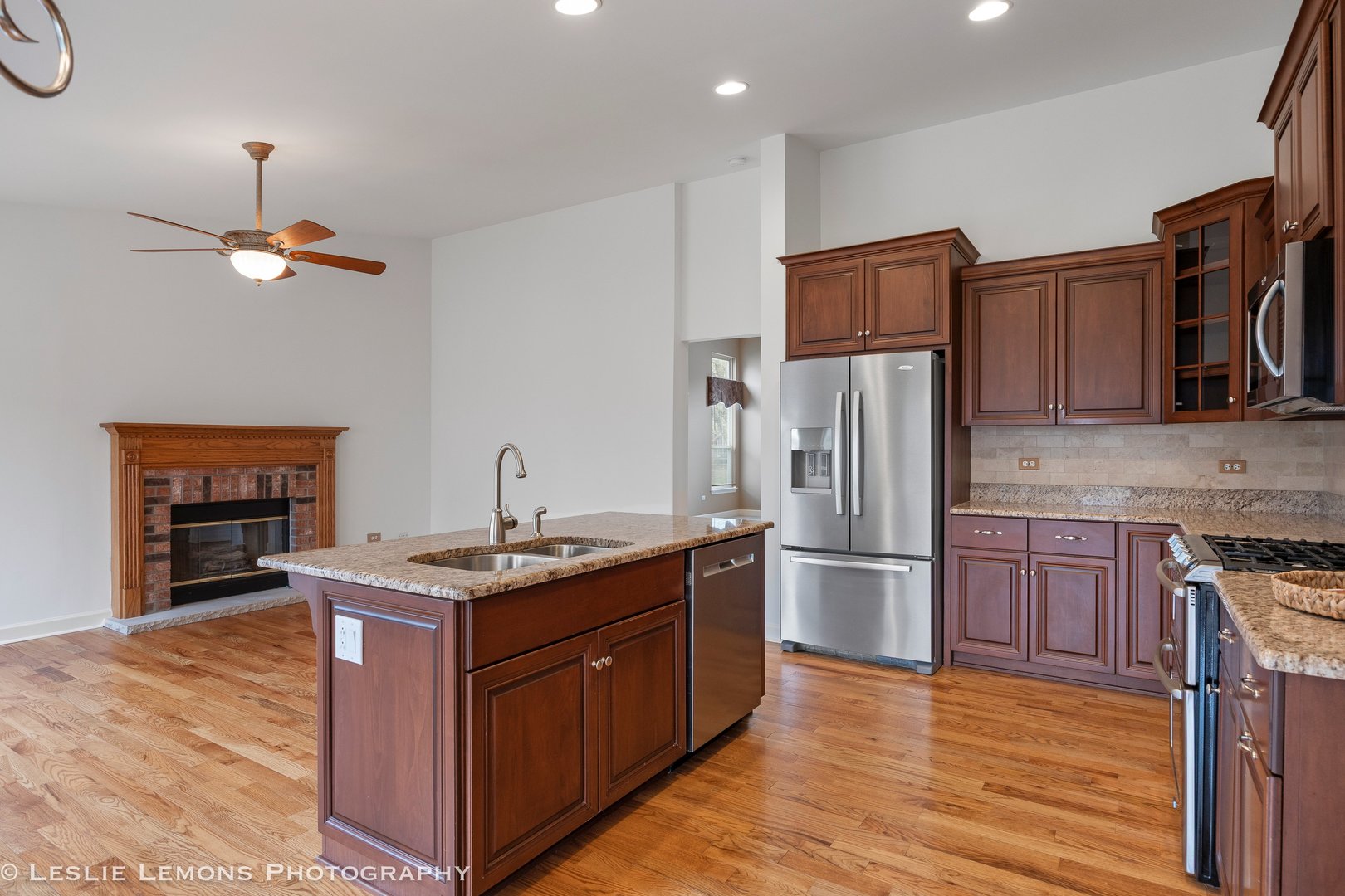 1940 Baldwin Way Bolingbrook, IL 60490 - Photo 7 of 28 a kitchen with stainless steel appliances granite countertop a refrigerator a stove and a wooden floors