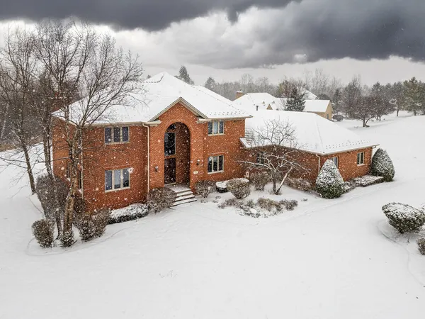 a view of a house with a snow in the yard