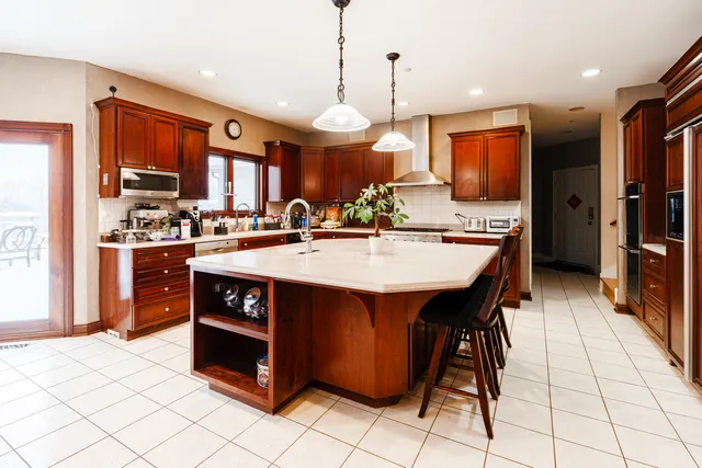 a kitchen with stainless steel appliances a sink stove and refrigerator