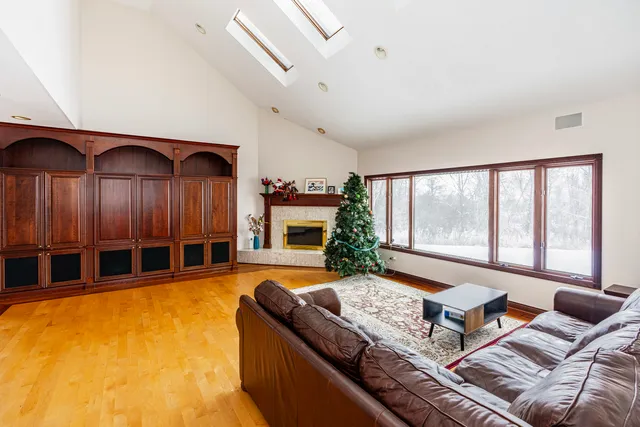 a living room with furniture large window and flat screen tv