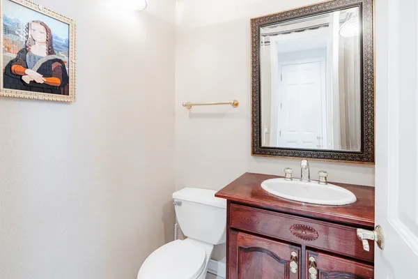 a bathroom with a toilet a sink and mirror