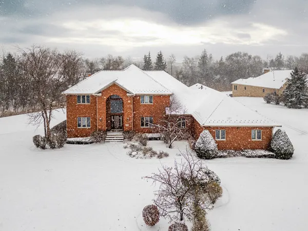 a view of a house with a snow in the yard