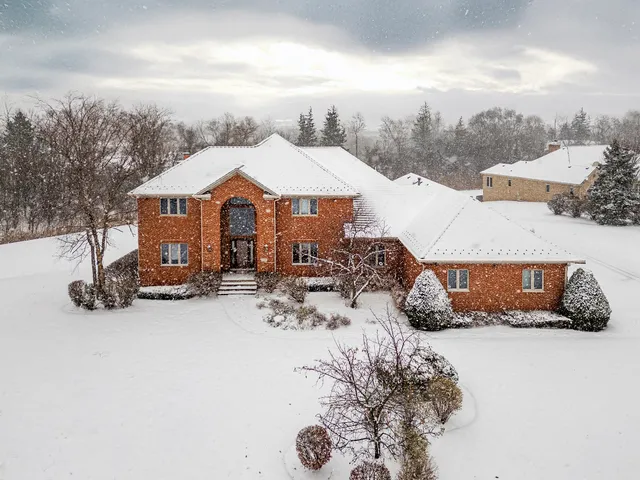 a view of a house with a snow in the yard