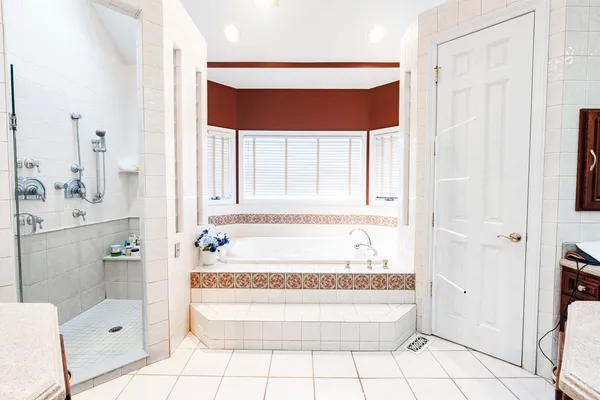 a bathroom with a bathtub and shower