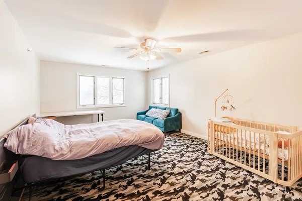 a bedroom with a bed and a chandelier