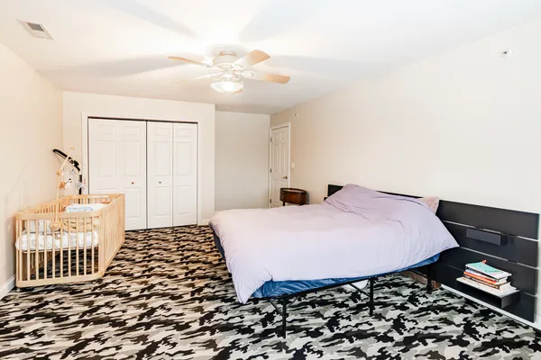 a bedroom with a bed and wooden floor