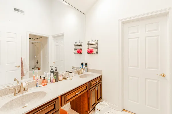 a bathroom with a sink vanity and a mirror