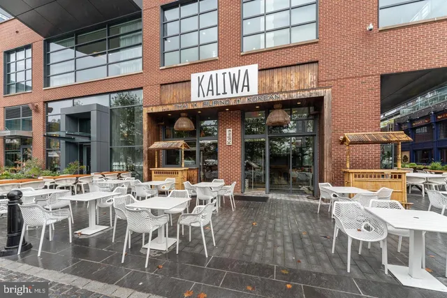 a view of a cafe with a table and chairs in front of it