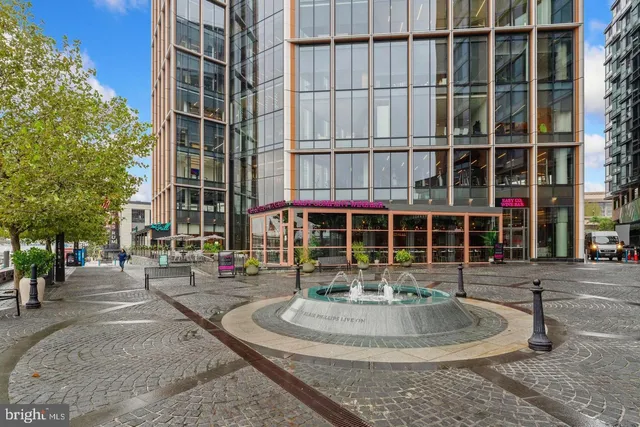 a swimming pool with barbeque oven in front of it