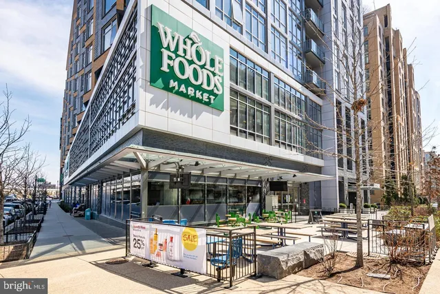 a view of a building with a umbrellas on a street