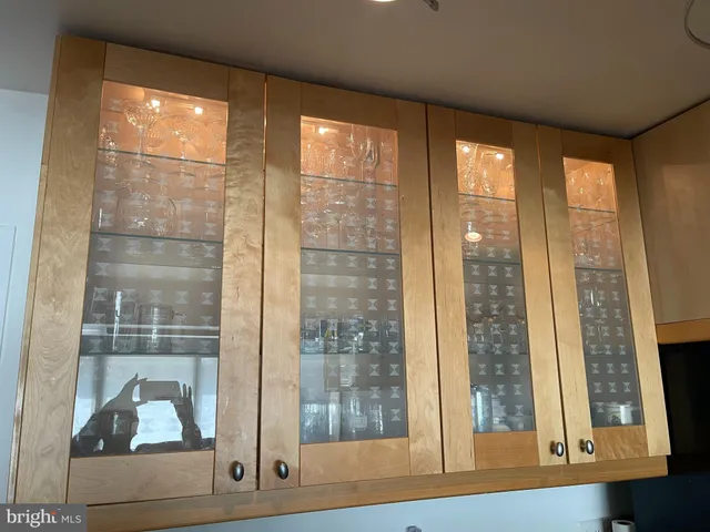 a view of a room that has a glass door and windows