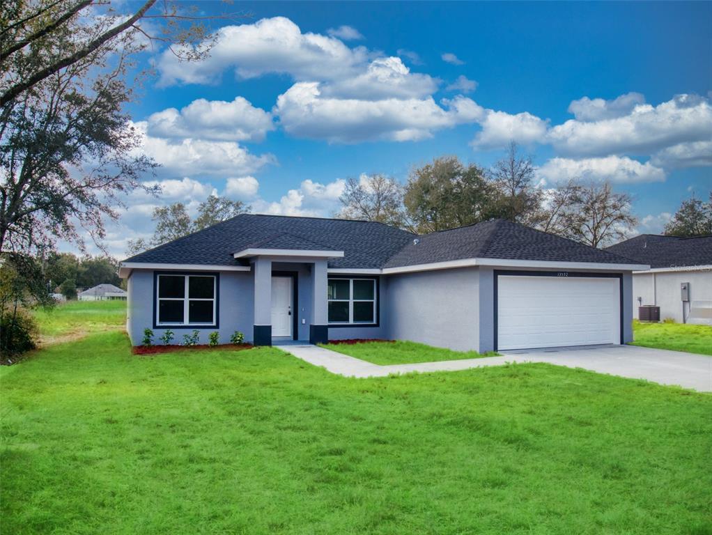 5518 Southwest 151 Street Road Ocala, FL 34473 - Photo 1 of 1 a view of a house with a yard and potted plants