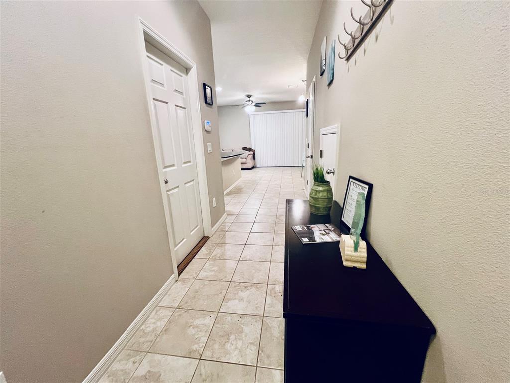 7007 Towne Lake Road Riverview, FL 33578 - Photo 13 of 16 a hallway with white cabinets and wooden floor