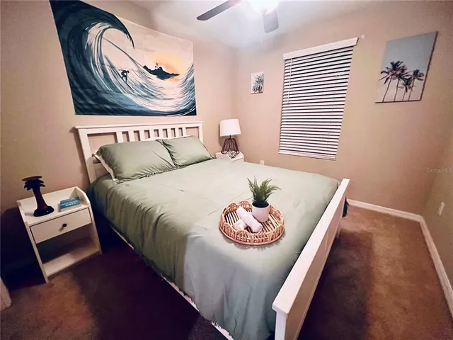 a bedroom with a bed and a table in it