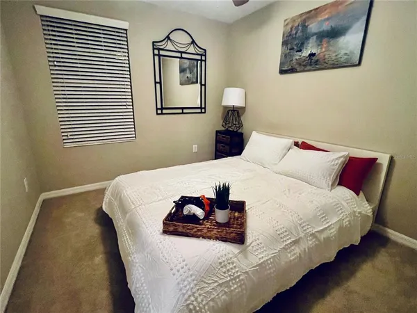 a bedroom with bed and a night stand