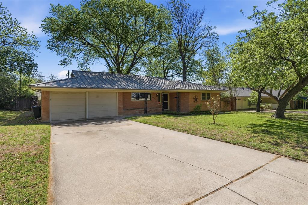 4105 Springbranch Drive Benbrook, TX 76116 - Photo 2 of 30 a front view of a house with a yard and garage
