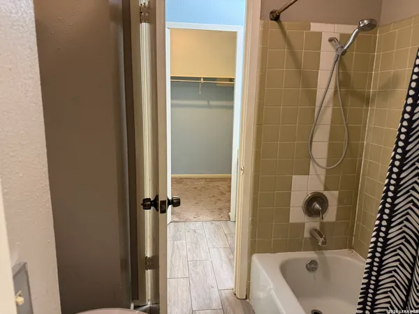 a white toilet sitting next to a sink