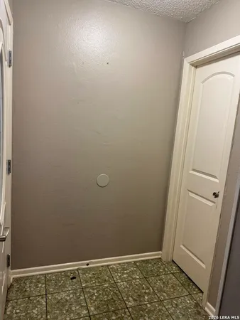 a bathroom with a granite countertop toilet and a sink