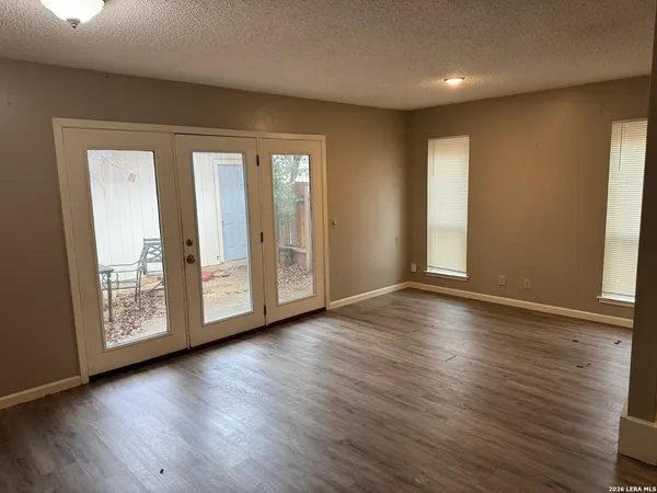 a view of a hallway with wooden floor and stairs