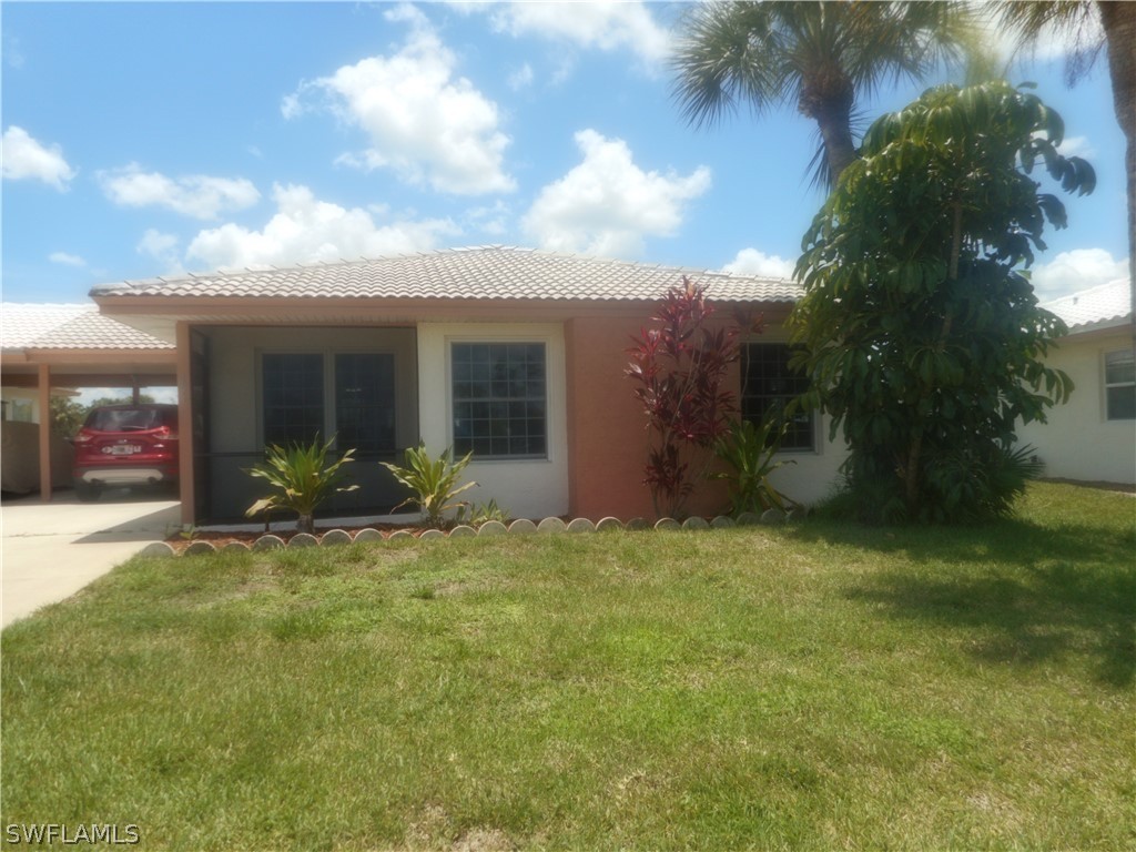 1614 Ridgecrest Street Lehigh Acres, FL 33936 - Photo 1 of 31 a view of a house with backyard and porch