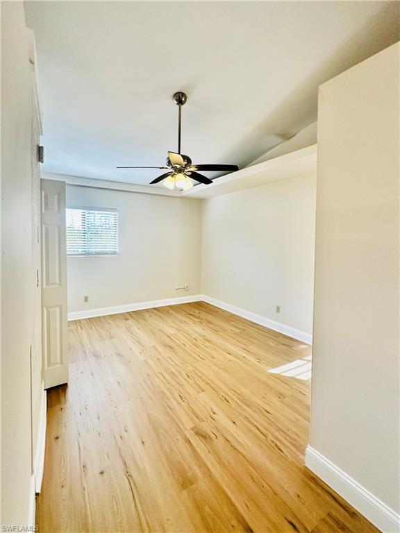 826 Wiggins Pass Road, Unit 310 Naples, FL 34110 - Photo 11 of 18 Master Bedroom featuring light wood-type flooring and a ceiling fan