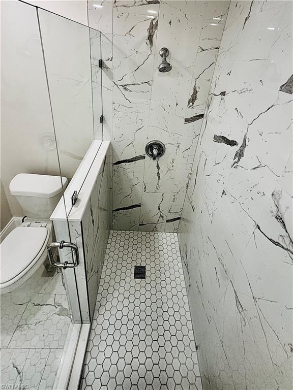 826 Wiggins Pass Road, Unit 310 Naples, FL 34110 - Photo 14 of 18 Full bathroom featuring a marble finish shower and toilet