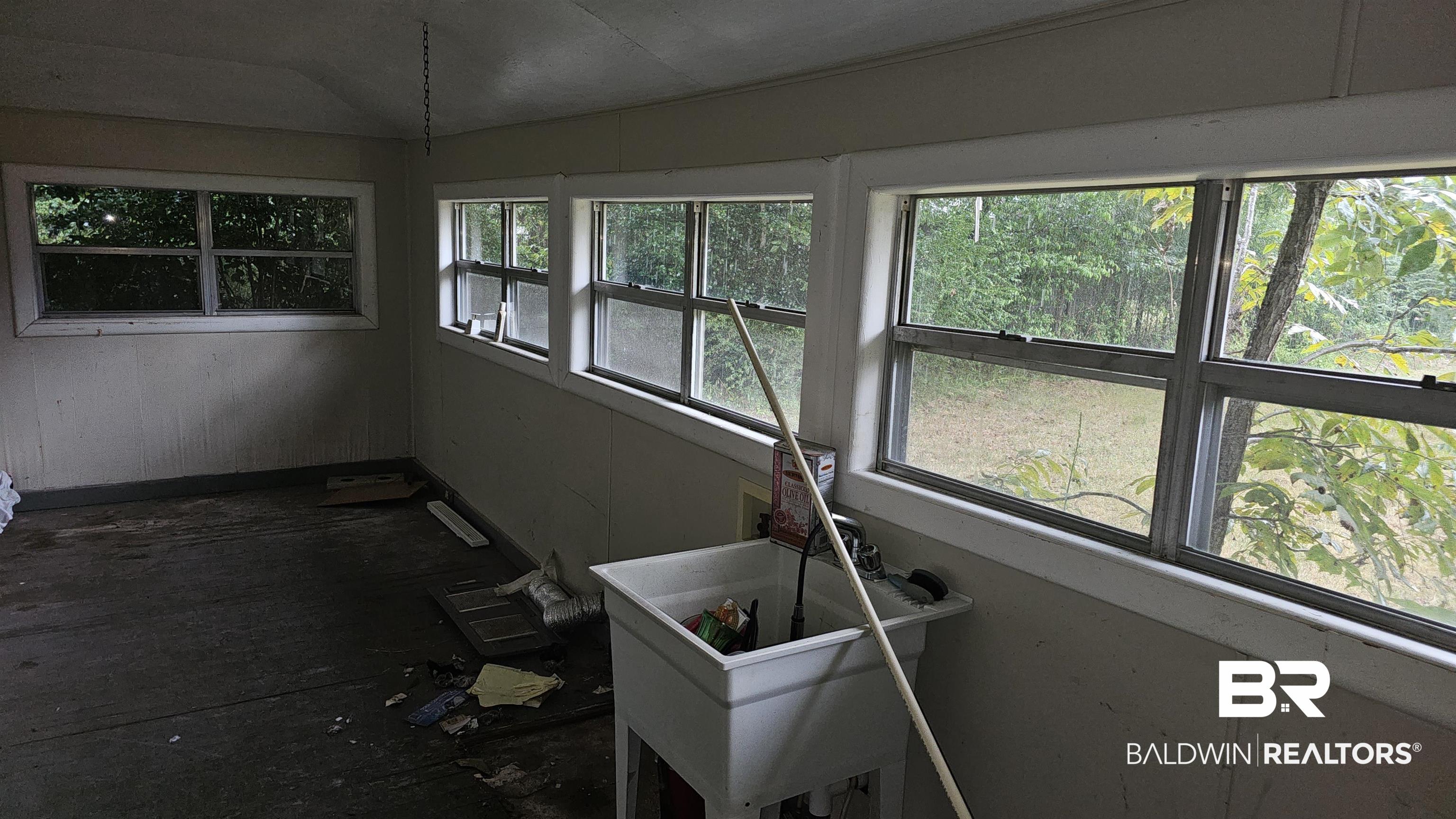 307 Scott Street Brewton, AL 36426 - Photo 7 of 19 Unfurnished sunroom with a healthy amount of sunlight and vaulted ceiling