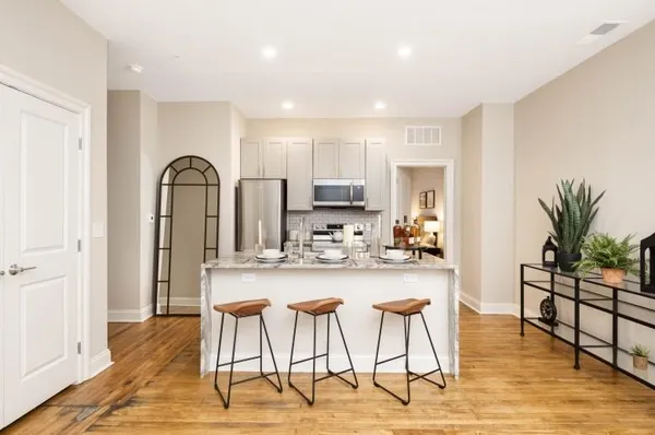 a view of a kitchen with dining table and chairs