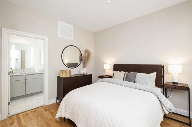 a bedroom with a bed and a dresser