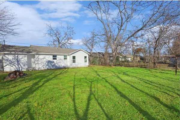 a view of house with backyard