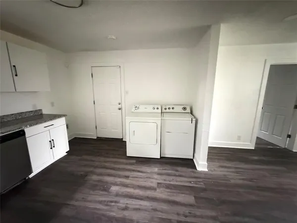 a utility room with cabinets washer and dryer