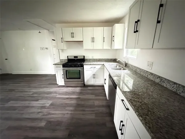 a kitchen with a stove and a sink
