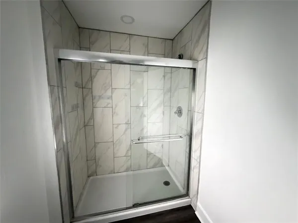 a bathroom with a glass shower door