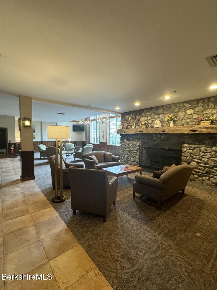 37 Corey Road, Unit 521 Hancock, MA 01237 - Photo 13 of 14 a living room with couches a coffee table and kitchen view with wooden floor