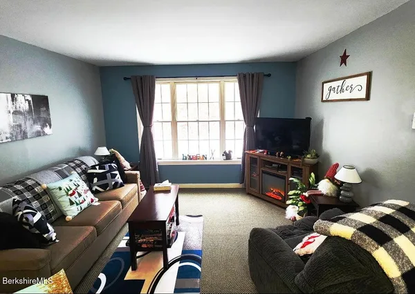 a living room with furniture window and a flat screen tv