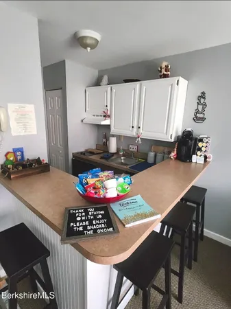 a kitchen with a stove a refrigerator and a dining table