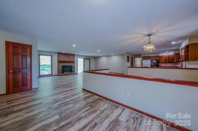 a room with wooden floor and a fireplace