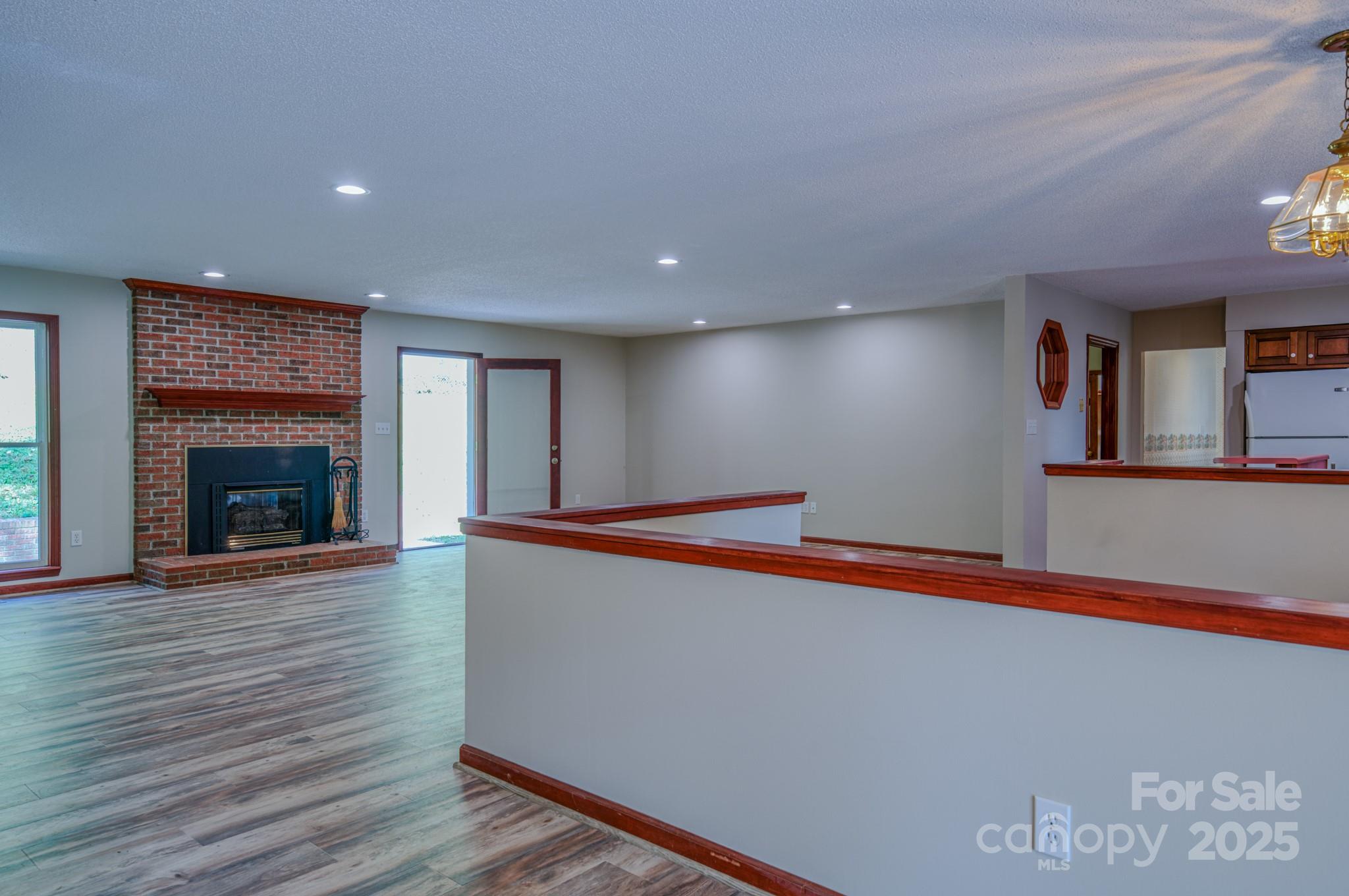 35 Byrd Road Candler, NC 28715 - Photo 15 of 46 a room with wooden floor and a fireplace