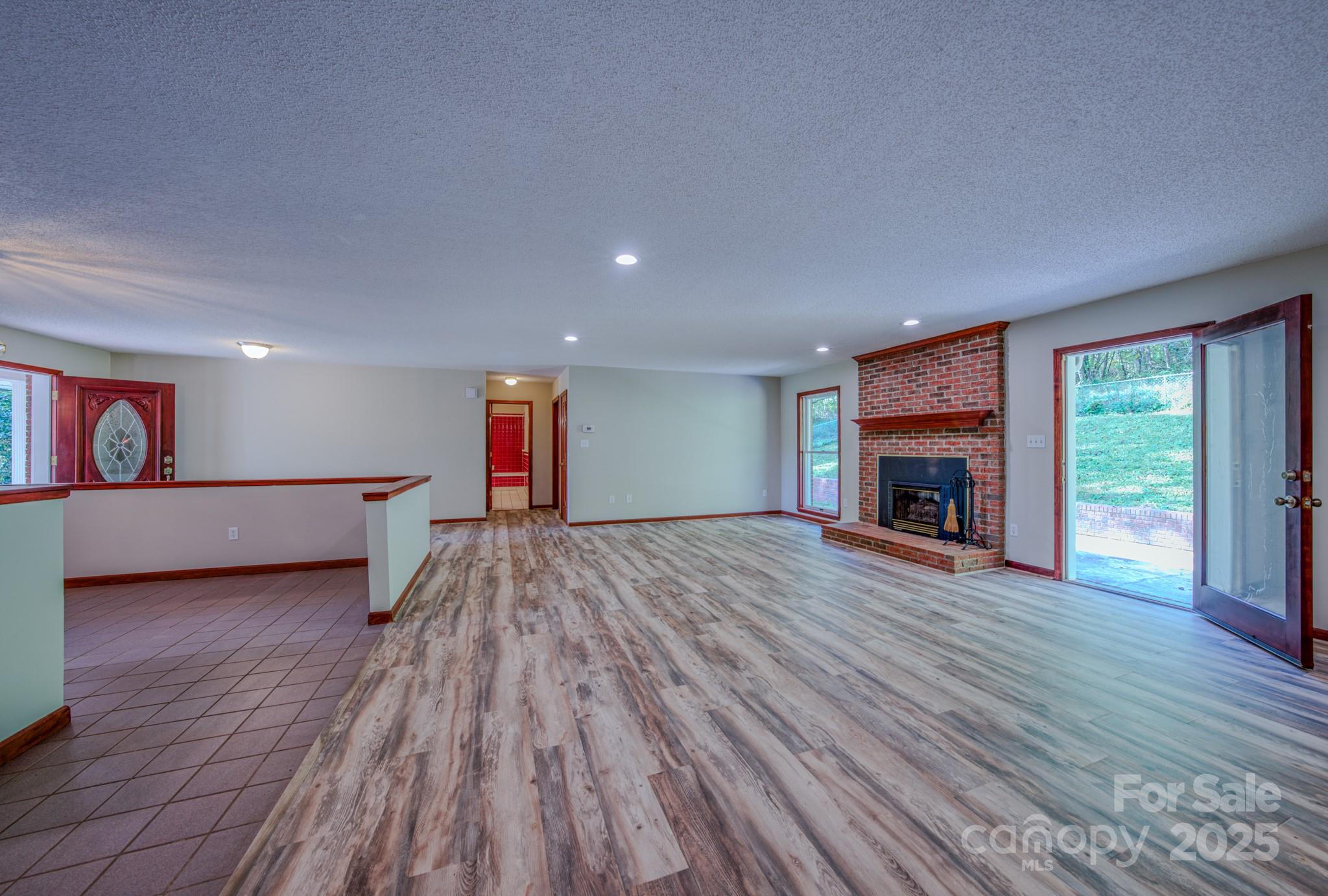 35 Byrd Road Candler, NC 28715 - Photo 16 of 46 a view of a livingroom with wooden floor and a fireplace