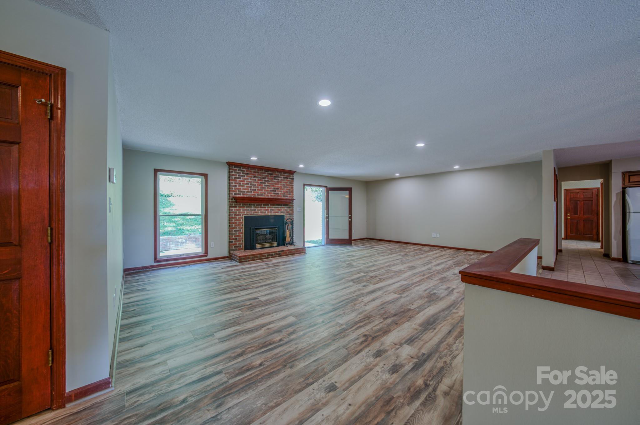 35 Byrd Road Candler, NC 28715 - Photo 17 of 46 a view of empty room with wooden floor and fireplace