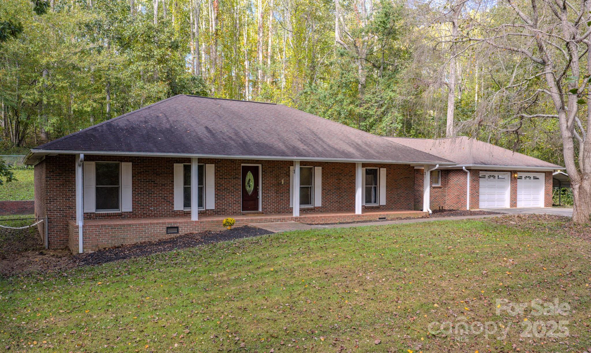35 Byrd Road Candler, NC 28715 - Photo 2 of 46 a front view of a house with a garden and porch