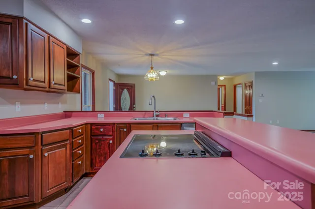a kitchen with chairs and wood floor