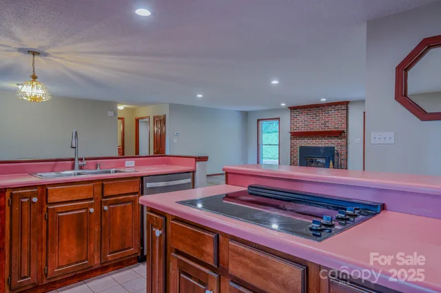 a kitchen with stainless steel appliances granite countertop wooden cabinets a refrigerator and a sink