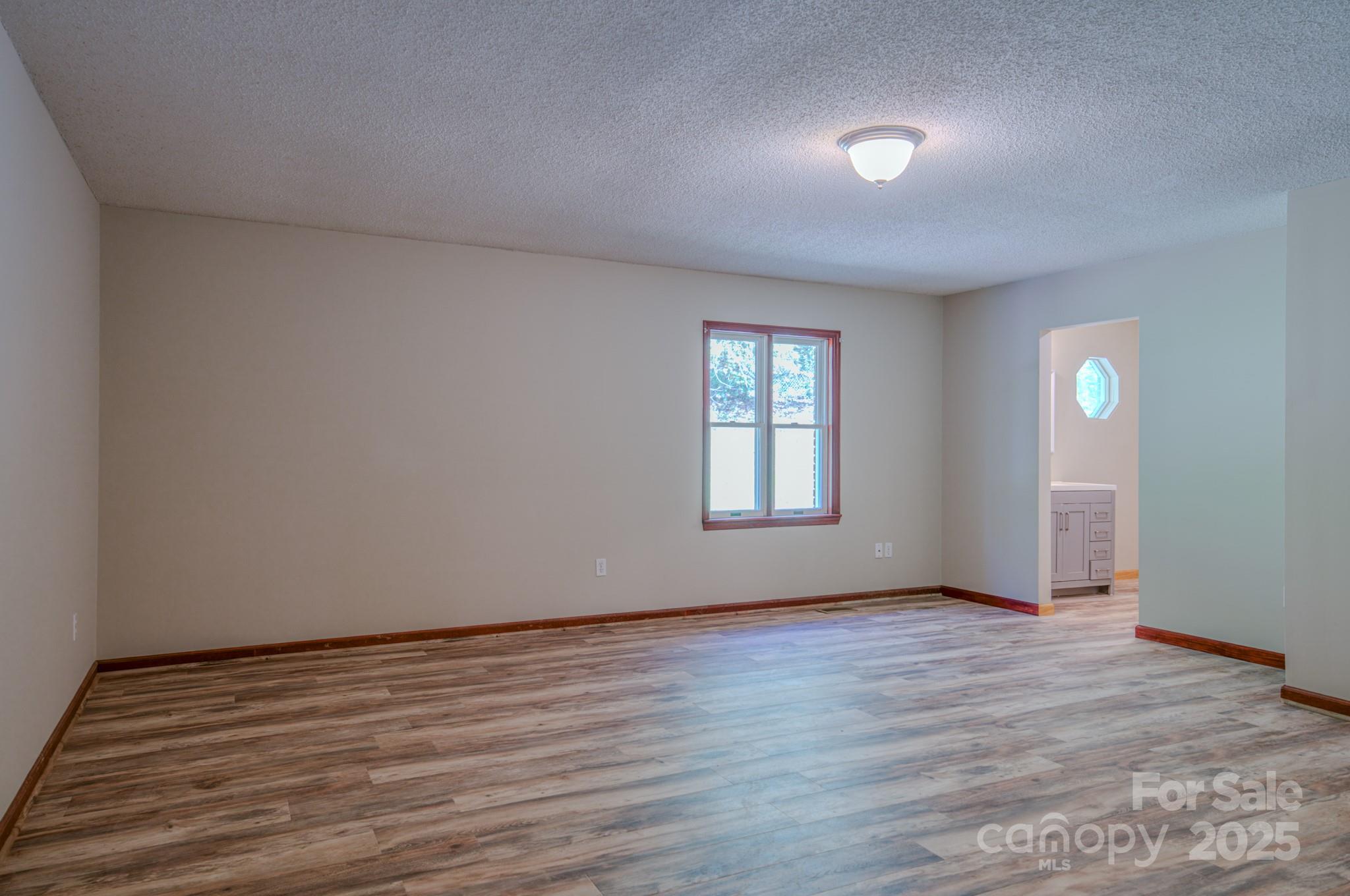 35 Byrd Road Candler, NC 28715 - Photo 26 of 46 an empty room with wooden floor and windows