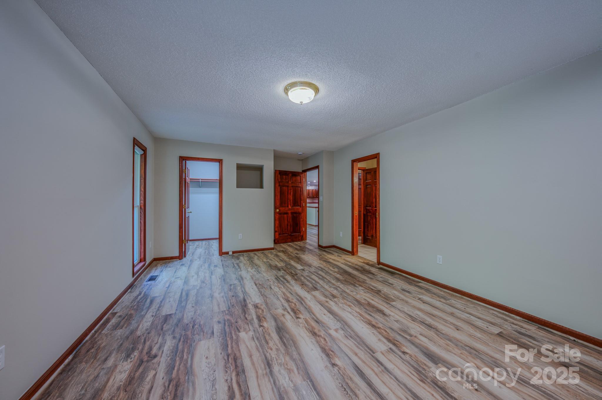 35 Byrd Road Candler, NC 28715 - Photo 32 of 46 a view of an empty room with wooden floor and window