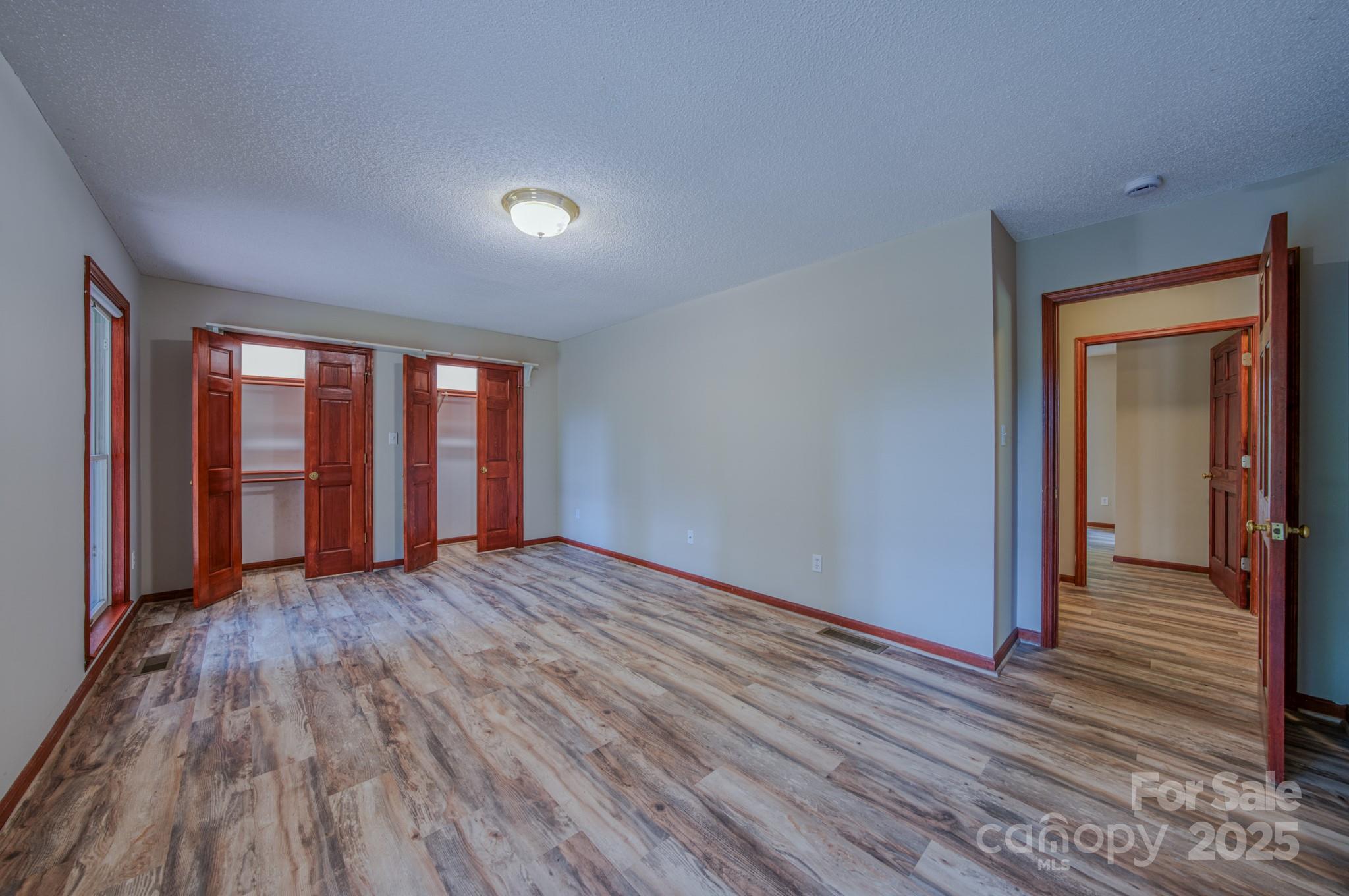 35 Byrd Road Candler, NC 28715 - Photo 38 of 46 wooden floor and windows in an empty room
