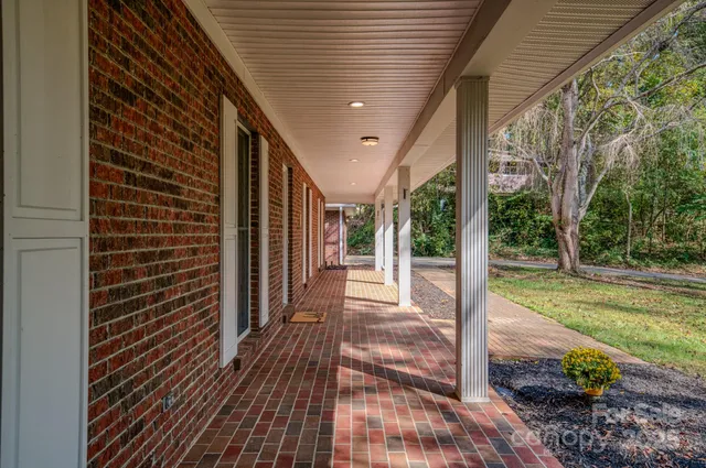 a view of a porch with wooden floor and fence