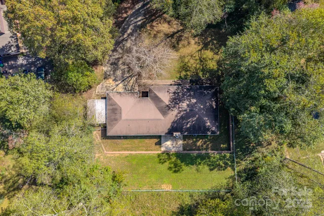 an aerial view of a house with a yard