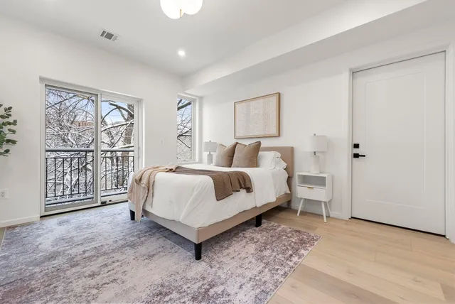 a bedroom with a large bed and a window