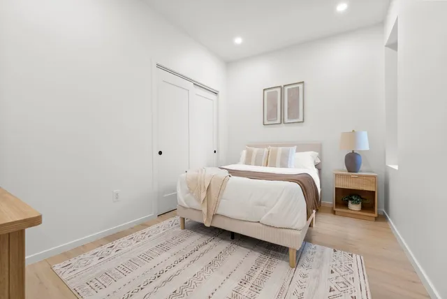 a bedroom with a bed and a lamp